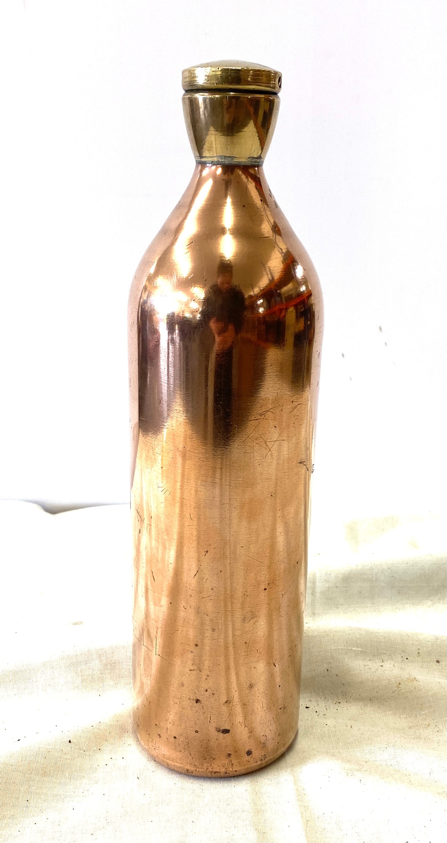 Copper bottle with brass screw top, approximate height 11 inches