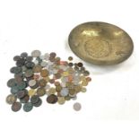 Copper bowl with a variety of coins