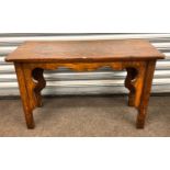 Oak gothic coffee table, measures approx 19" tall 32" wide 14.5" deep