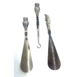 Antique silver handled shoe horns and button hook, owls with red eyes and Mr Punch