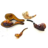 Four antique carved Meerschaum eagle claw pipes