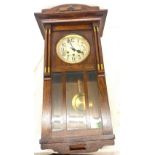 Edwardian three keyhole oak wall clock, measures approximately 30 inches by 15 inches.