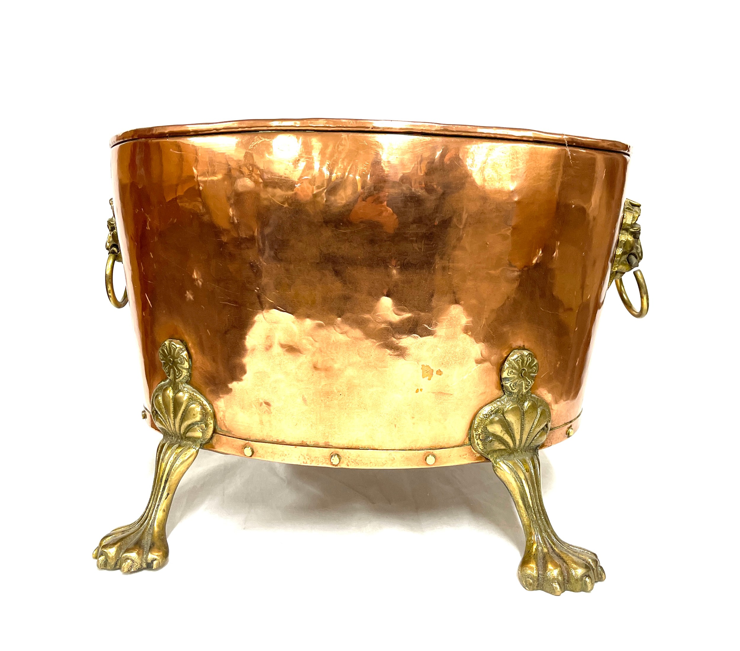 Antique copper log bin with brass claw feet and lion's heads Height 30cm, Width 32 cms