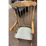 Spindle back rocking chair, embroidered seat