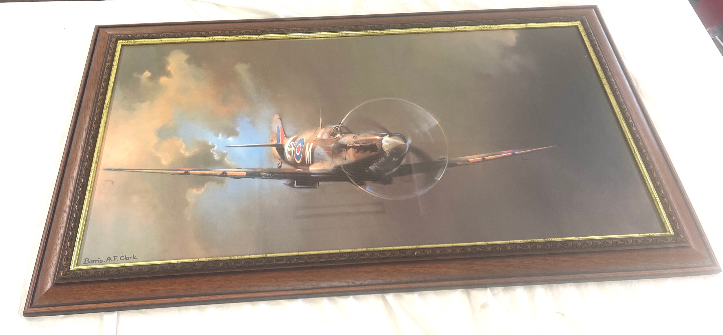 Framed print of a Spitfire by Barrie A F Clark, approximate measurements: Height 11 inches, Width 40