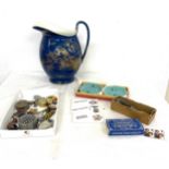 Assortment of items to include decorative jug, brooches, trinkets etc