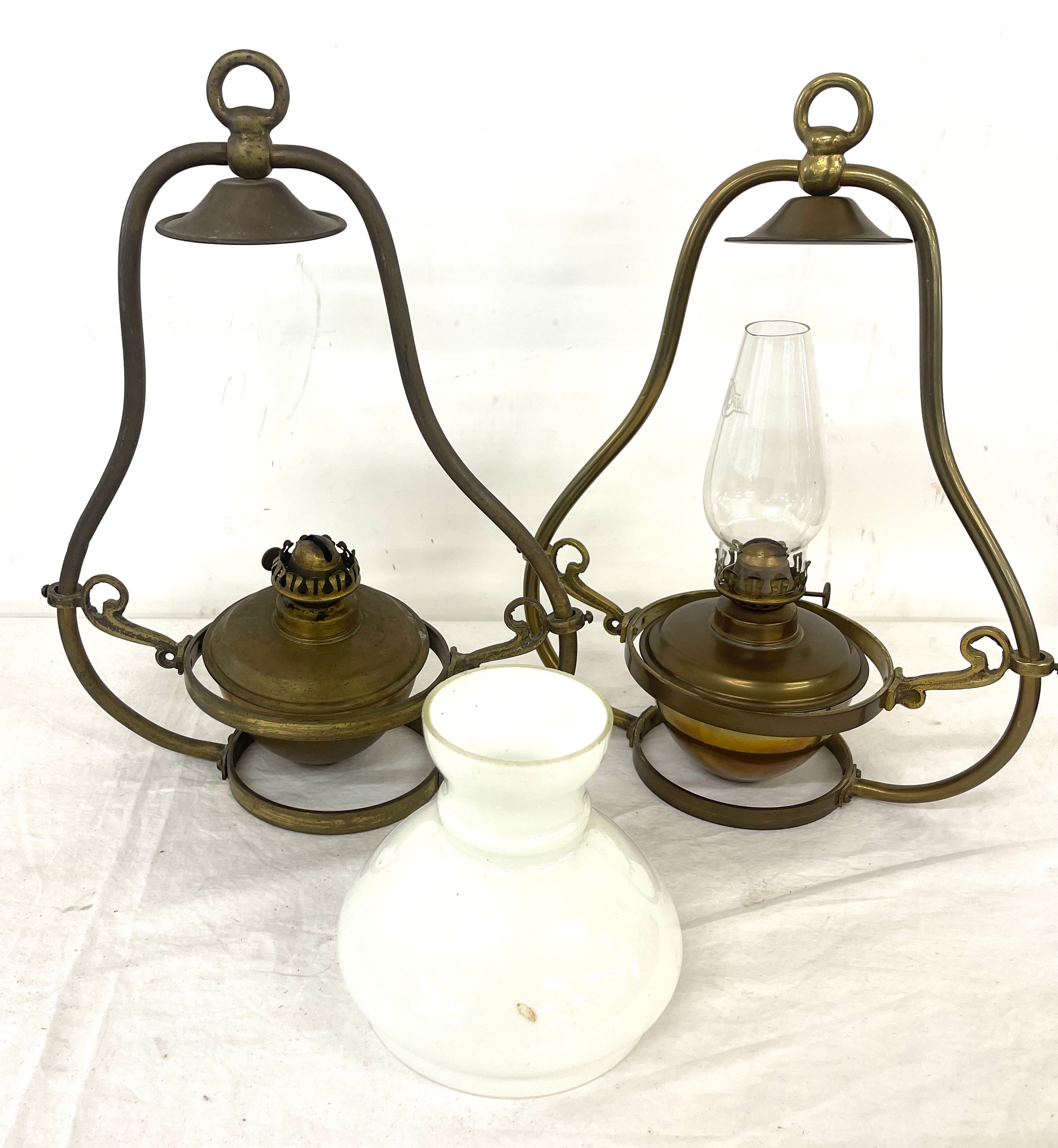 Pair hanging oil lamps, one has a funnel and shade