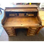 Oak panelled roll top desk, measuring approximately 45 inches in heigh, 48 inches in width and 34