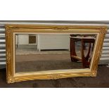 Large gilt framed mirror, approximate measurements: 28 x 49.5 inches