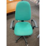 Green fabric office chair on wheels