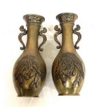 Pair of bronze budist vase (winged garuda birds" measure approx 7" tall one vase has a dent