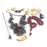 Selection of vintage jewellery includes bone brooches pendant bead necklace and hat pin etc