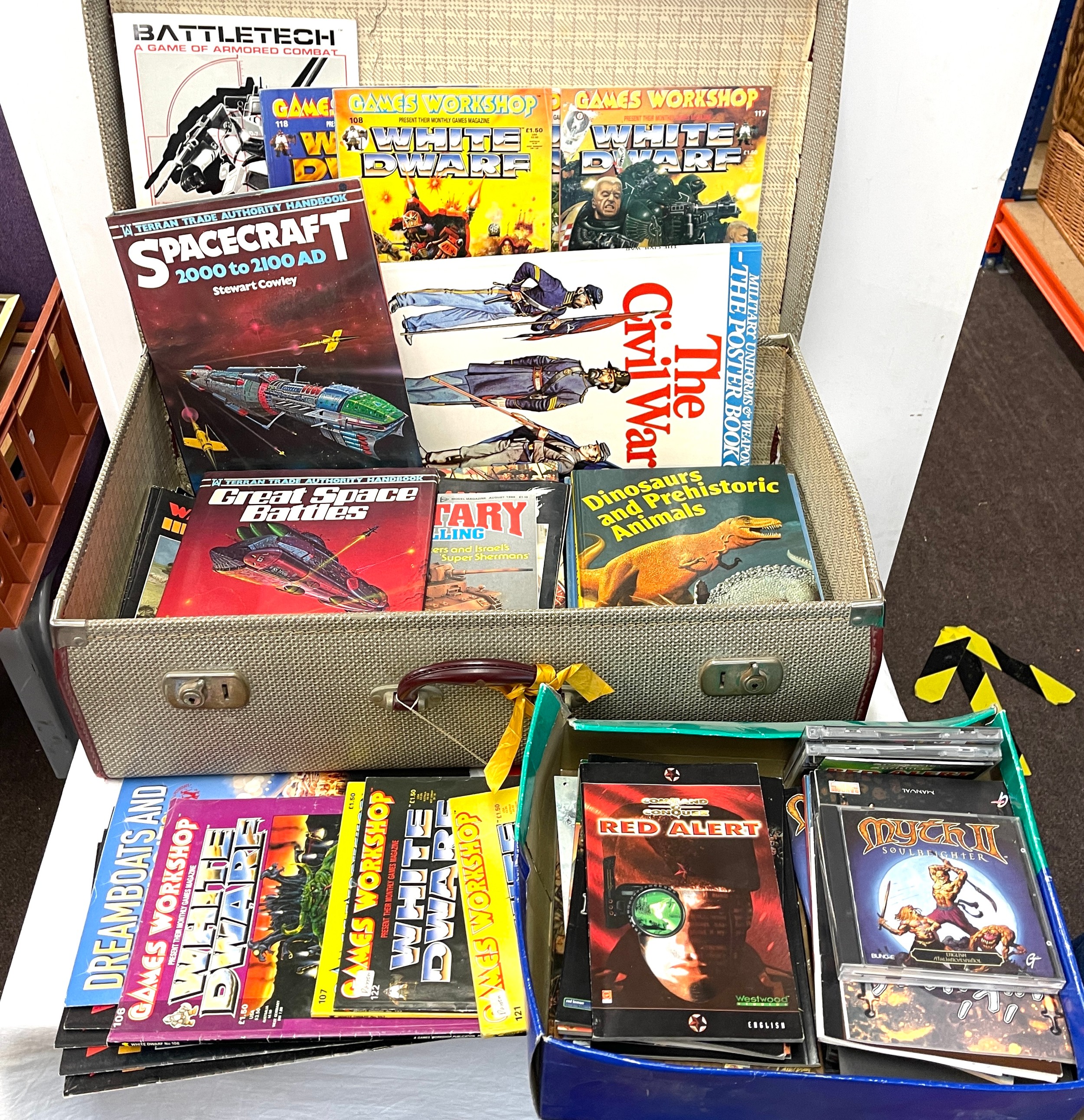 Vintage suitcase containing vintage computer games, magazines including White Dwarf, Work games