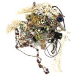 Large selection of assorted costume jewellery includes brooches, necklaces etc