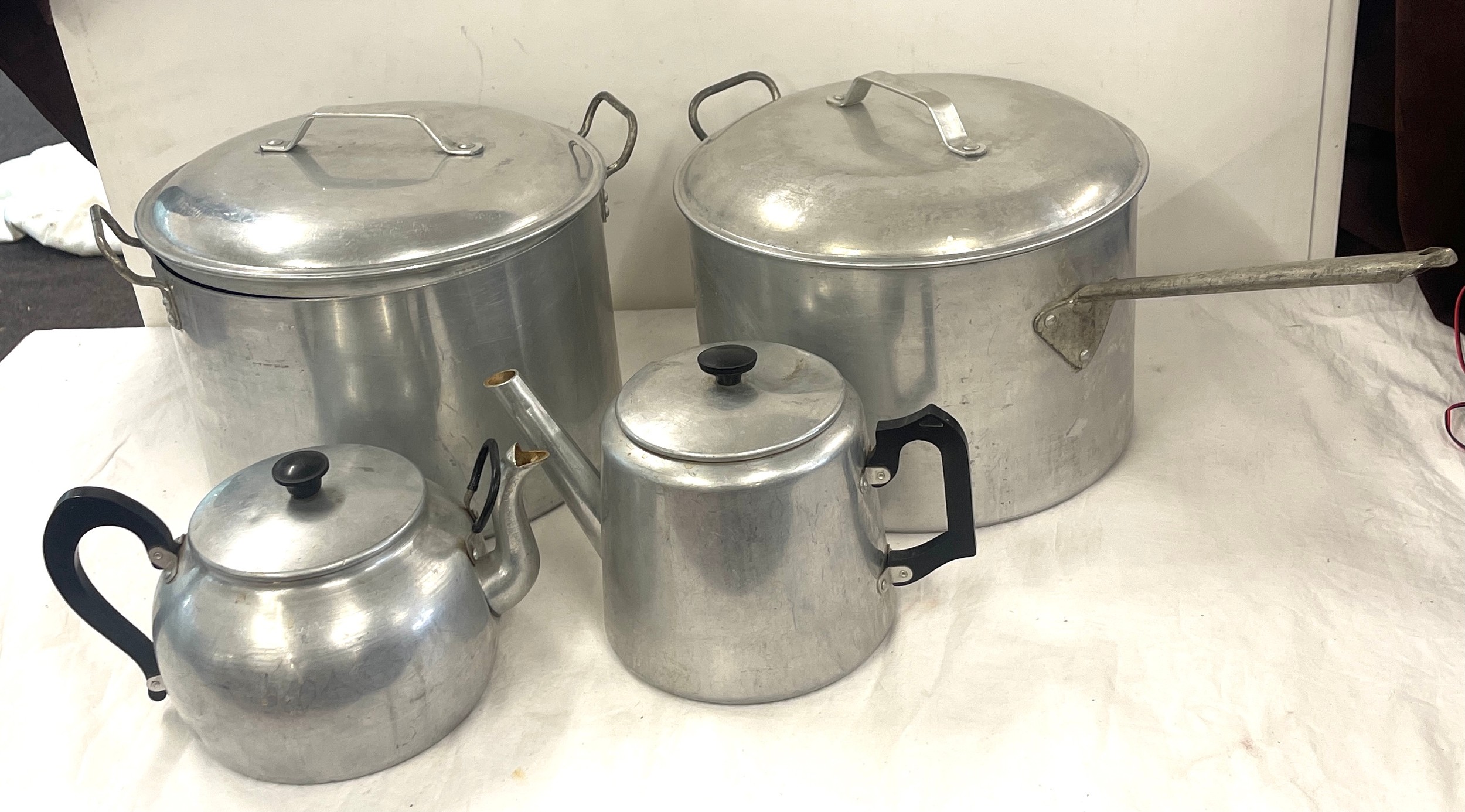 Large stainless steel pans and tea pot, approximate diameter of pans: 12 inches