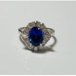 18ct white gold oval tanzanite and diamond cluster ring. T 3.00ct. D 0.82ct. WGI9624126573