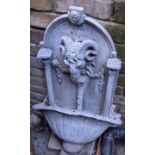 An Antique Lead Garden Fountain. Cast with a Rams head hung with Husk drapes