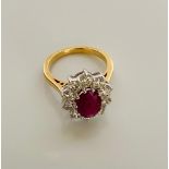 An 18ct white and yellow gold oval ruby and diamond cluster ring. R 1.50ct. D 1.50ct. WGI9624126661