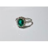18ct white gold fine quality oval emerald (gem quality colour) and diamond cluster ring with diamond