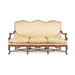 A late 19th century French beechwood and parcel gilt three-seater settee or canapé