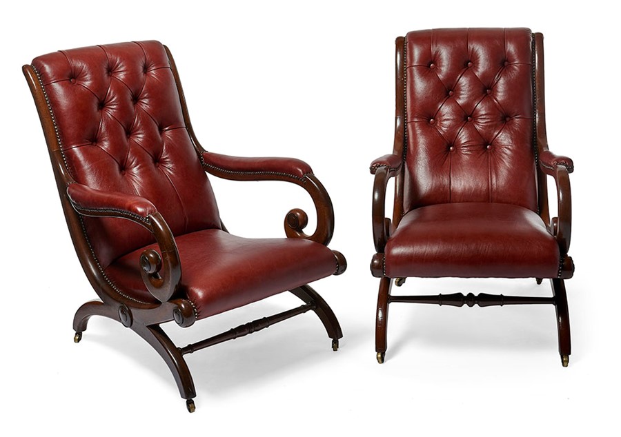 A matched pair of Regency mahogany library open armchairs