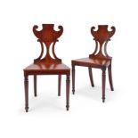 A pair of Regency mahogany hall chairs