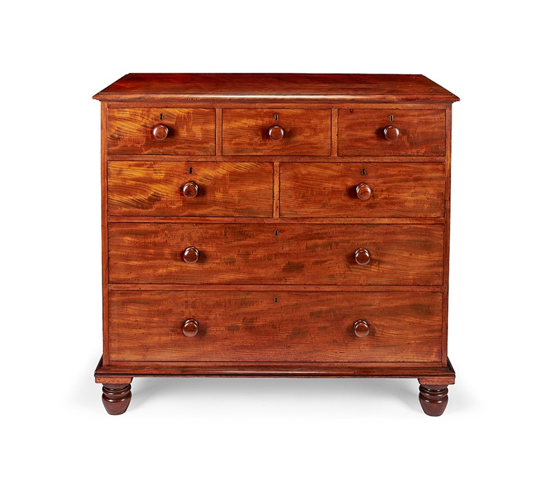 A George IV 'plum pudding' and 'fiddle-back' mahogany chest attributed to Gillows