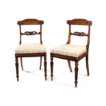 A set of eleven Regency rosewood carved dining chairs