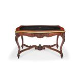 A Napoleon III carved rosewood and gilt brass bound serpentine writing table