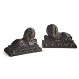 A pair of small early 19th century patinated bronze recumbent lions