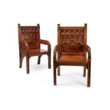 A matched pair of 19th century Gothic style oak carved throne open armchairs