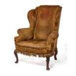 A Queen Anne carved walnut wing armchair
