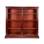 A tall mahogany open bookcase