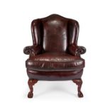 A George I style oak carved wing armchair