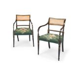 A pair of Regency ebonised and parcel gilt open armchairs