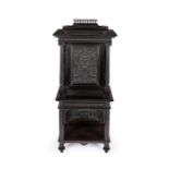 A late 19th century French ebony and ebonised carved cabinet on stand