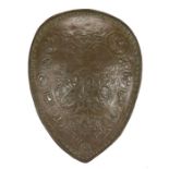 A bronzed plaster decorative shield in the style of Elkington & Co.