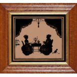 A pair of late 19th / early 20th century silhouettes on glass of seated figures