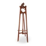 A late 19th century carved walnut and parcel gilt standing folding easel