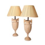 A pair of substantial neo-classical style white carved stone table lamps with shades