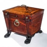 A Regency carved mahogany sarchophagus shaped celleret