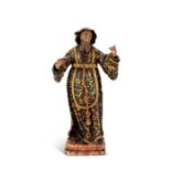 An 18th century polychrome and parcel gilt figure of a saint