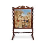An early Victorian rosewood carved needlework fire screen