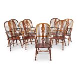A set of eight late 19th/early 20th century yew-wood windsor open armchairs