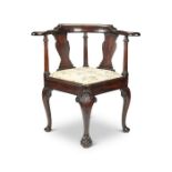 A George II carved mahogany corner chair