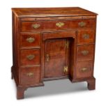 An 18th century and later walnut crossbanded and featherbanded kneehole desk