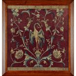 An 18th century needlework panel in a later frame