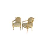 A pair of George III style carved giltwood armchairs in the style of Morel and Seddon
