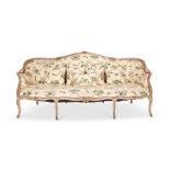 A George III cream and parcel gilt carved serpentine settee