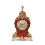A late 19th century Louis XIV style scarlet-tortoiseshell and brass inlaid mantel clock